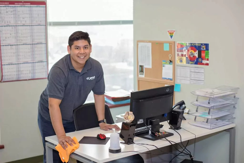 Corvus Franchisee cleaning an office to desk to prevent allergies